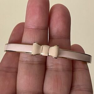 Kate Spade pink enamel, gold plated metal bow bangle bracelet